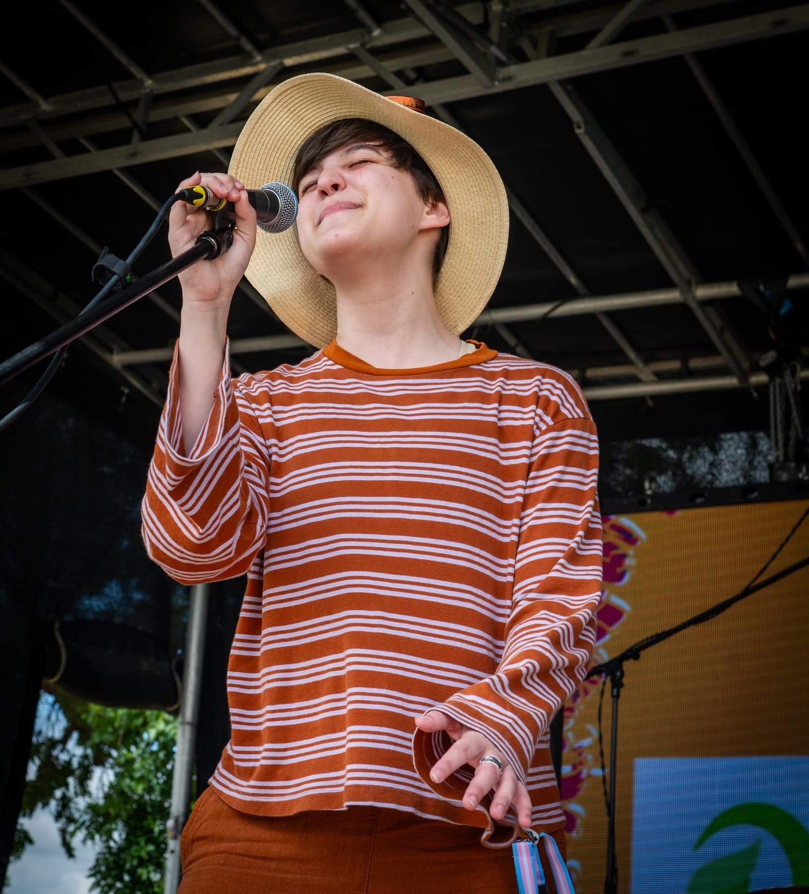 Singer performing in a hat at Woo Fest 2026